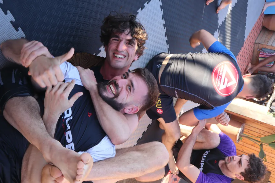 Training partners smiling together on the mats between rounds