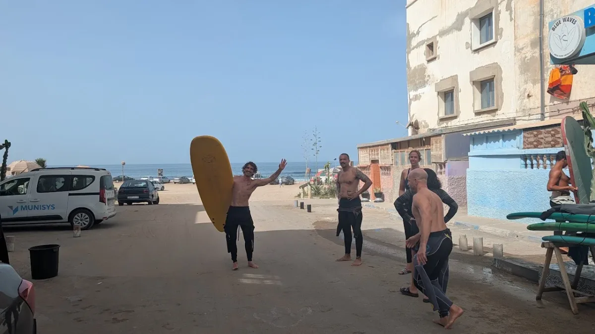 September 2026 participants with surfboards on the way to the beach
