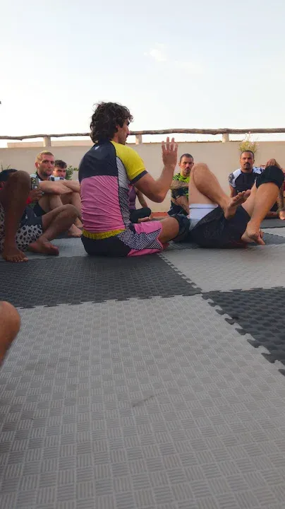 September 2026 participants gathered around a no-gi demonstration on outdoor mats